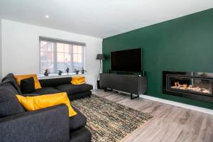 a living room with a couch and a fireplace at BOURNECOAST: *HOT TUB*BBQ HUT*GYM*GARDEN* HB6340 in Bournemouth