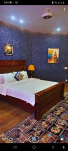 a bedroom with two beds and a blue wall at Pearl Executive Villa Islamabad in Islamabad