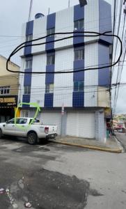 a white car parked in front of a building at Ap. No centro da cidade in Garanhuns