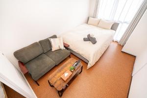 an overhead view of a room with a couch and a table at 新宿歌舞伎町東新宿站3分钟，徒步伊势丹4分钟免费Wi-Fi！ in Tokyo