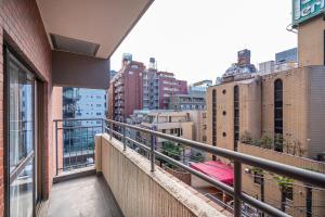 an apartment balcony with a view of a city at 新宿歌舞伎町東新宿站3分钟，徒步伊势丹4分钟免费Wi-Fi！ in Tokyo