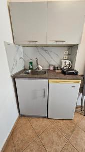 a kitchen with a sink and a counter top at ASTORIA lindos in Lindos