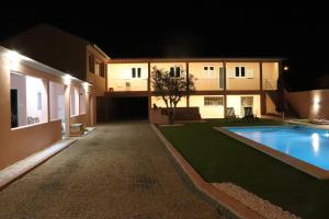 a house with a swimming pool at night at Casa do Avô Gil in Seixo
