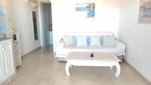 a living room with a couch and a coffee table at Sardegna Top Golfo Di Marinella in Golfo Aranci
