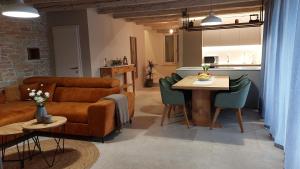 a living room with a couch and a table at VILA ŠKARLANIJA, Umag in Umag