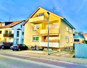 a apartment building with a motorcycle parked in front of it at Sky Studio Apartment 1,5 Zimmer für 4 Leute Zentral 35qm S-Bahn Mercedes Benz in Magstadt