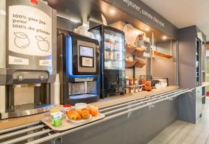a bakery with a counter with pastries on it at B&B HOTEL CALAIS Coquelles Tunnel sous La Manche in Coquelles