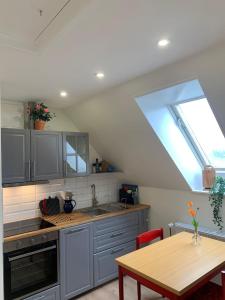 a kitchen with a sink and a table and a window at Haus Ostwind - Wohnung 2 in Dahme +36 photos