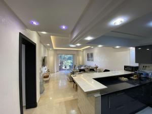 a large kitchen and living room with a counter top at Luxury Marina Appartement Agadir in Agadir