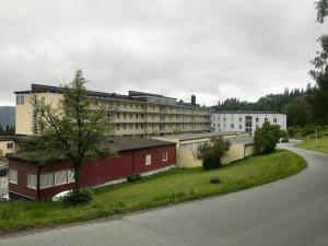 a building on the side of a road next to a building at Leilighet med utsikt ved bymarka in Trondheim