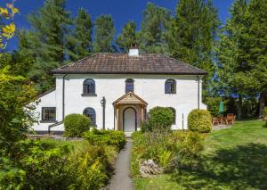 a white house with a pathway in front of it at Barn Owl Cottage Wheddon Cross in Wheddon Cross
