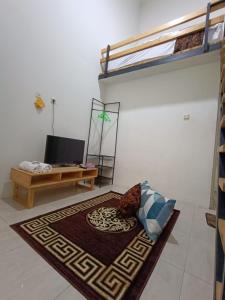 a living room with a couch and a rug at Jogja Amor Hotel in Demangan