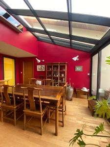 a dining room with a large wooden table and chairs at la Palisse in Peaugres