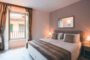 Postel nebo postele na pokoji v ubytování Hotel Palazzo Benci + 37 fotografií