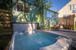 a hot tub in the backyard of a tiny house at Cosy Shepherds Hut with hot tub in the Scottish Highlands in Stittenham