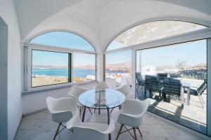 a dining room with a view of the ocean at The Zen Villa in Akrotiri