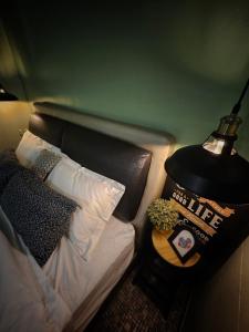 a bedroom with a bed with a lamp on a table at 85 Boutique Hotel in Ipoh