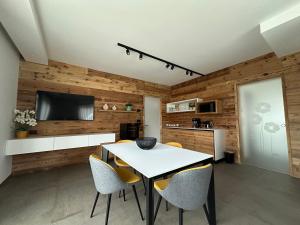 a kitchen and dining room with a table and chairs at Origini Holidays in Sedico