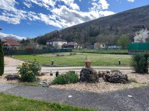 a garden with a fire hydrant on the side of a road at Gîte chez Marco in Peyrieu