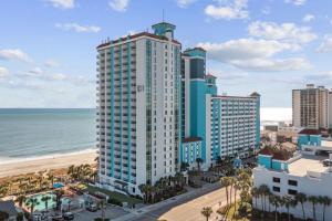 an aerial view of a tall building next to the beach at Ocean View Blues- Caribbean Resort 7th fl in Myrtle Beach