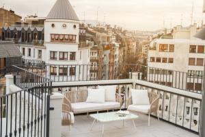 a balcony with two chairs and a coffee table at Letoh Letoh San Sebastián in San Sebastián