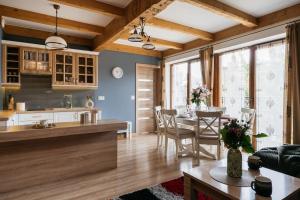 a kitchen and dining room with a table and chairs at Apartament Skibówki by LoftAffair in Zakopane