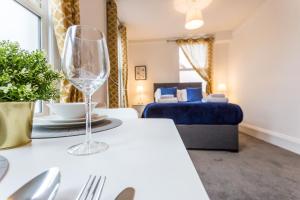 a living room with a wine glass on a table at West Street Studio Apartments in Southend in Southend-on-Sea