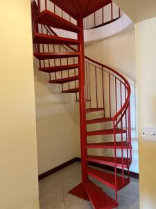 a red spiral staircase in a room at The penthouse beachfront in Mombasa