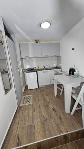a kitchen with a table and a white table and a counter at ASTORIA lindos in Lindos +23 photos
