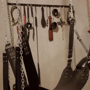 a bunch of chains and utensils hanging on a wall at Les Secrets du Château - Love Room in Lichtenberg