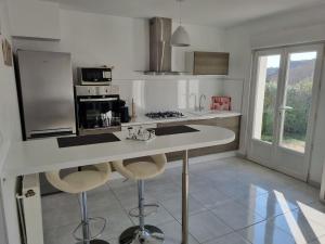 a white kitchen with a counter and a stove at La Désirade Audresselles, charmante maison à 250 m de la plage in Audresselles