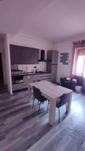 a kitchen with a table and chairs in a room at B&B Sa Casadina in Cagliari