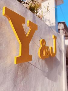 a yellow sign on the side of a building at Y&J in Seminyak