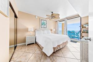 a bedroom with a bed and a view of the ocean at Romar Place Unit 904 in Orange Beach