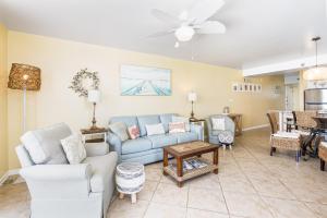a living room with a blue couch and chairs at Romar Place Unit 904 in Orange Beach