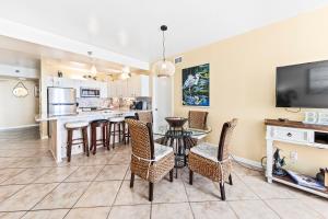 a kitchen and dining room with a table and chairs at Romar Place Unit 904 in Orange Beach +36 photos
