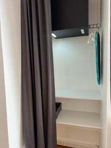 a closet with a curtain in a room at Le refuge du 15 in Paris