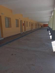 an empty hallway of a building with yellow walls at hotel el retorno in Catriel