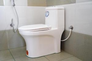 a white toilet in a bathroom with a shower at Angel Holidays in Munnar