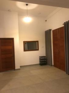 an empty room with a door and a window at Hudakala Villa Hanthana in Kandy