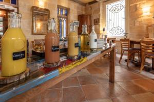 a row of bottles on a counter in a room at Hôtel La Tour Intendance in Bordeaux