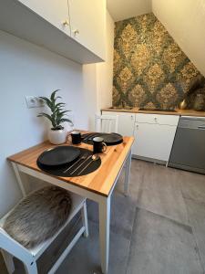 a kitchen with a wooden table with a chair at Deluxe Apartment in Duisburg