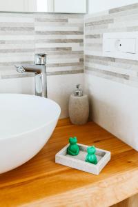 a bathroom with a white bowl and a sink at Agriturismo Il Canto delle rane in Finale Ligure