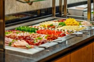 a buffet line with many different types of food at CityClass Hotel am Dom in Cologne