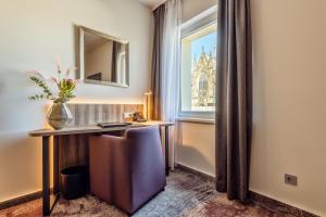 a hotel room with a desk and a window at CityClass Hotel am Dom in Cologne