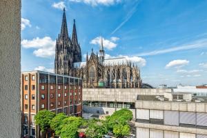 a cathedral with two spires in a city at CityClass Hotel am Dom in Cologne