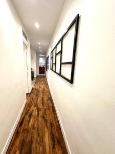 a hallway with white walls and a wooden floor at Spacieuses Flats Paris Porte de Versailles in Paris