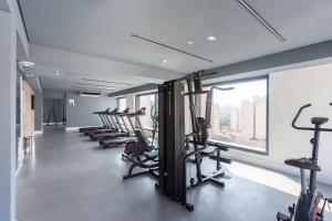 a gym with a row of treadmills and exercise bikes at BHomy Perdizes - Uma quadra do Allianz Pq VA403 in Sao Paulo