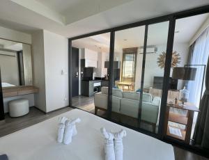 a hotel room with towels on a table at The Deck Condominium by Lofty in Patong Beach
