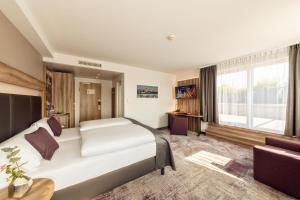 a hotel room with a bed and a large window at CityClass Hotel am Dom in Cologne